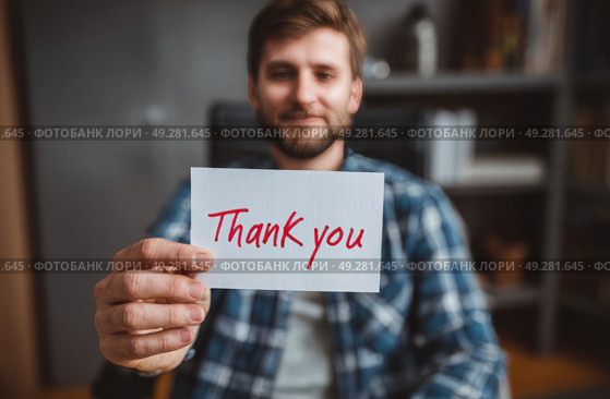 A man holding a white card that says "Thank You" in red. Стоковое AI-изображение, AI-художник Ярославский Максим / Фотобанк Лори