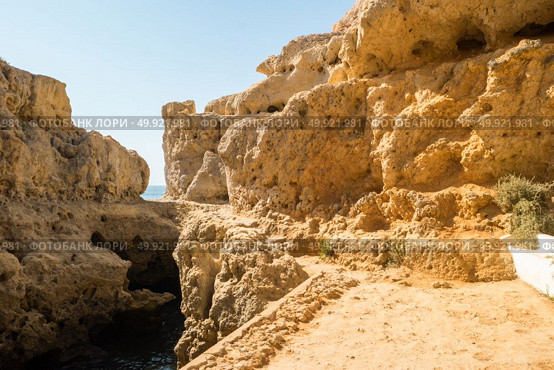 A pool of natural sea water between sandstone cliffs at Algar Seco. Carvoeiro Algarve Portugal. Стоковое фото, агентство Ingram Publishing / Фотобанк Лори