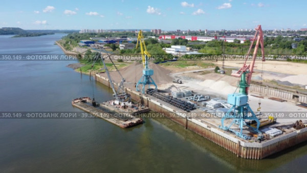 A port crane unloads a barge. River port, dredging works. Aerial photography. Video. High quality  footage. Стоковое видео, видеограф Egor Sarantstv / Фотобанк Лори