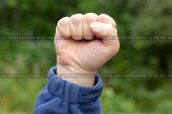 A raised clenched fist. Protests in the city. A concept. Стоковое фото, фотограф Александр Поташев / Фотобанк Лори