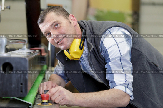 a worker with noise cancelling looking at camera. Стоковое фото, агентство Ingram Publishing / Фотобанк Лори