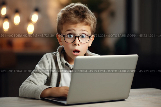 A young Caucasian male worker in glasses looks unhappy while sitting at a desk with a laptop during a workday in a dimly lit office. Стоковое AI-изображение, AI-художник Sergey Grishin / Фотобанк Лори