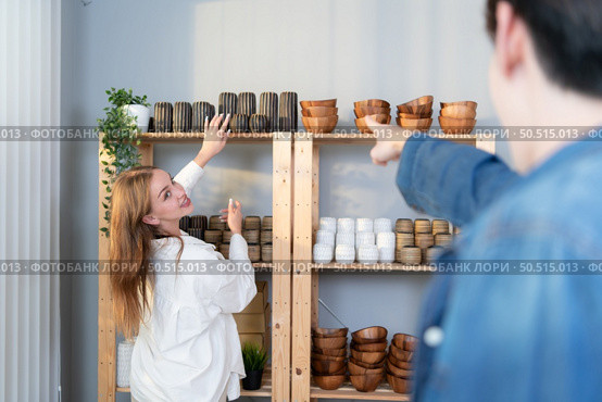 A young couple runs a small business making clay jewelry. They support one another as they work toward becoming larger business in the future. Стоковое фото, агентство Ingram Publishing / Фотобанк Лори