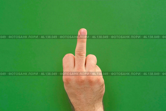 Abusive gesture fuck on chromakey. Male hand shows middle finger, offensive gesture isolated on green background. Fuck You concept. Close Up. Bad expression, provocation. Rude attitude. Fuck off sign. Стоковое фото, фотограф Марина Демидюк / Фотобанк Лори