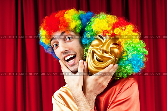 Actor with maks in a funny theater concept. Стоковое фото, агентство Ingram Publishing / Фотобанк Лори