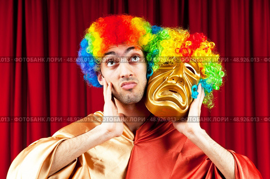 Actor with maks in a funny theater concept. Стоковое фото, агентство Ingram Publishing / Фотобанк Лори