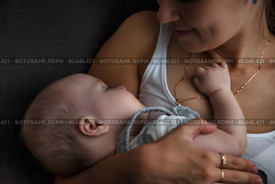 Adorable newborn baby sleeping on hands loving happy mother at home, closeup. Mommy with kid together in bedroom. Mom care 6 months old infant child. Concept of motherhood, maternity. Copy text space. Стоковое фото, фотограф Aleksandr Golubev / Фотобанк Лори
