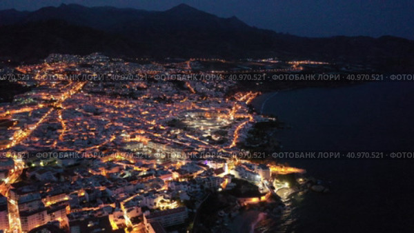Aerial view of illuminated Nerja city at Mediterranean coast, Costa del Sol, Spain. Стоковое видео, видеограф Яков Филимонов / Фотобанк Лори