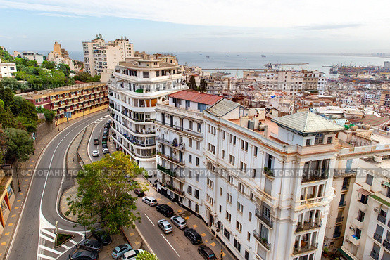 Aerial view of street, houses and rooftops in center of Algiers. View of seaport and Mediterranean Sea. Republic of Algeria. Стоковое фото, фотограф Евгений Ткачёв / Фотобанк Лори