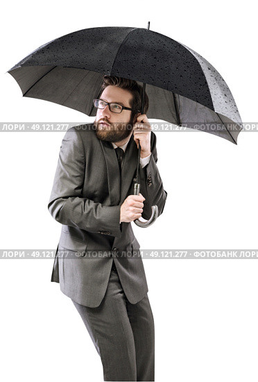 Afraid businessman hiding himself under the black umbrella. Стоковое фото, агентство Ingram Publishing / Фотобанк Лори
