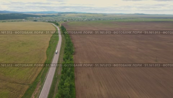 Agricultural landscape captured in aerial view near rural area. Стоковое видео, видеограф Гурьянов Андрей / Фотобанк Лори