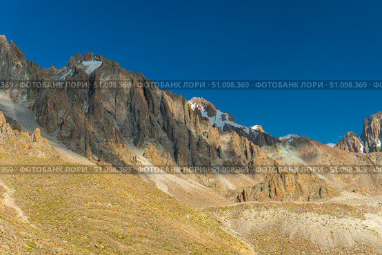 Ala-Archa Rocky mountain slopes, snow patches, steep cliffs, create an ideal environment for trekking, climbing, alpinism, hiking, backpacking, mountaineering, and outdoor adventure activities. Стоковое фото, фотограф Андрей Ка / Фотобанк Лори