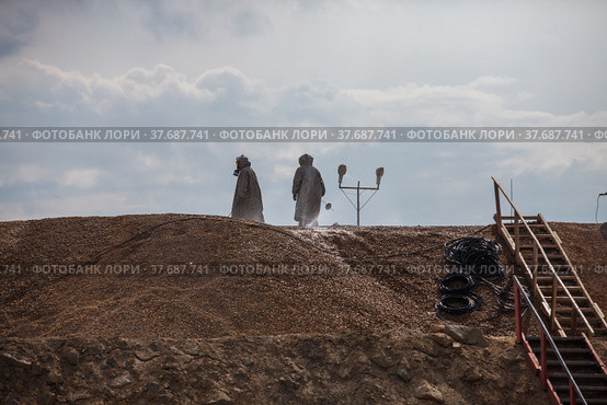 Almaty region, Kazakhstan - June 04, 2012: Mining and processing plant of Altynalmas company. Chemist use sodium cyanide NaCN for gold refining. Hazmat suits and gas masks. Стоковое фото, фотограф Alexey Rezvykh / Фотобанк Лори