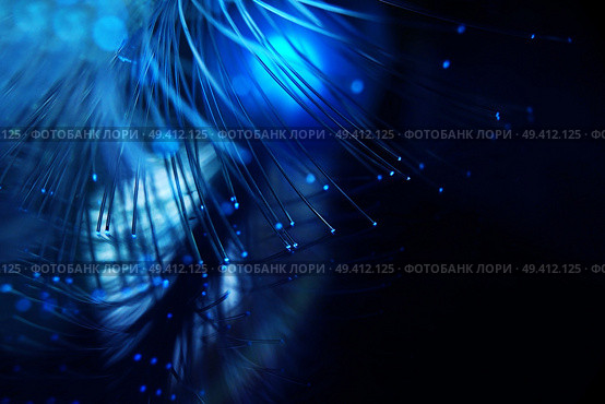 An amazing and vibrant macro of blue fiber optical pipes that illuminate making sparkles and glitters with black background. Стоковое фото, агентство Ingram Publishing / Фотобанк Лори