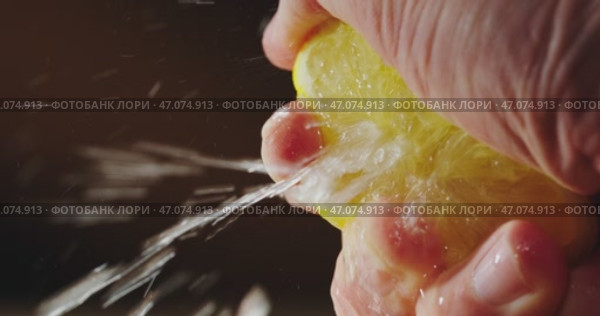 An Extreme CloseUp and Detailed View of a Fresh Lemon Slice Being Held in a Hand. Стоковое видео, видеограф Владимир Ковальчук / Фотобанк Лори