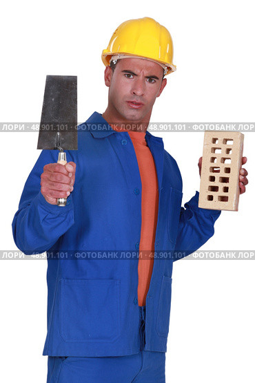 Angry tradesman holding a brick and trowel. Стоковое фото, агентство Ingram Publishing / Фотобанк Лори