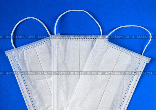 Antiviral mask on blue background. Protective masks. Стоковое фото, фотограф Попова Ольга / Фотобанк Лори