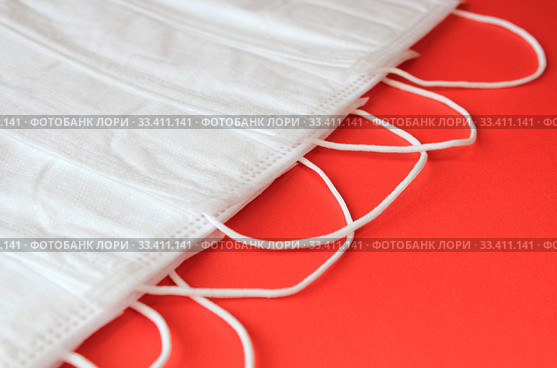 Antiviral masks on red background with copy space. Protective masks. Стоковое фото, фотограф Попова Ольга / Фотобанк Лори