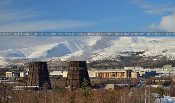 Apatity, Murmansk region, Russia, March 12, 2024: Territory of industrial area of Second apatite-nepheline concentration factory in north of city at foot of Vudyavrchorr Khibin mountain. Редакционное фото, фотограф Алексей Антипов / Фотобанк Лори