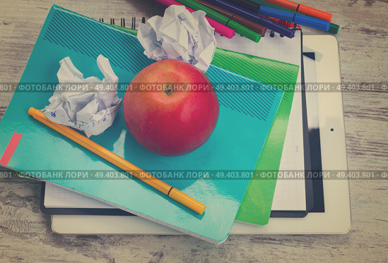 Apple with school supplies on white wooden table, top view, retro toned. Apple with school supplies. Стоковое фото, агентство Ingram Publishing / Фотобанк Лори