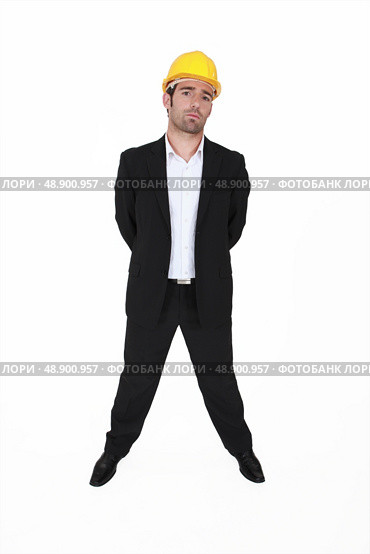 Arrogant architect stood with his hands behind his back. Стоковое фото, агентство Ingram Publishing / Фотобанк Лори