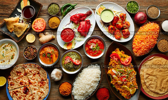 Assorted Indian recipes food various with spices and rice on wooden table. Стоковое фото, агентство Ingram Publishing / Фотобанк Лори