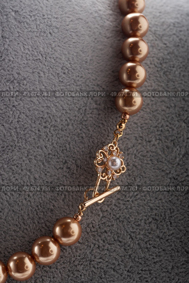 author handmade golden  pearls necklace presented on maneken. fashion and jewelry concept. macro shot. Стоковое фото, агентство Ingram Publishing / Фотобанк Лори