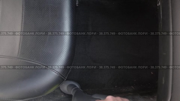 Автолюбитель убирает салон автомобиля пылесосом. Стоковое видео, видеограф Гребенев Пётр / Фотобанк Лори