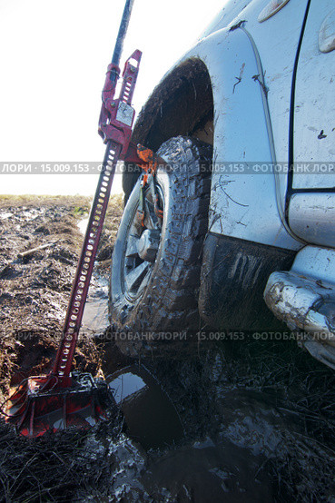 Автомобиль поднимают домкратом из грязи. Стоковое фото, фотограф Юрий Стройкин / Фотобанк Лори
