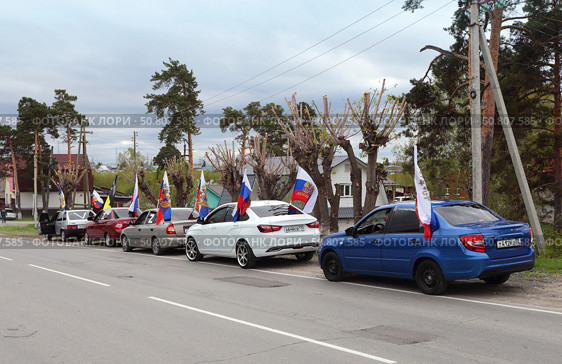 Автомобили с флагами и сигналами формируют колонну. 9 мая 2025 г. в городе Заводоуковске. Редакционное фото, фотограф Анатолий Матвейчук / Фотобанк Лори