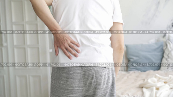 Back pain, kidney inflammation, man suffering from backache at home, health problems concept. Стоковое видео, видеограф Станислав Тарко / Фотобанк Лори