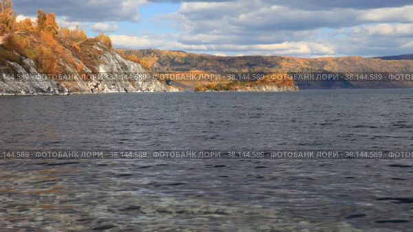 Baikal Lake in September. Slyudyanka village. View from the shore to  natural landmark - Cape and  Shaman Peninsula on sunny day. Beautiful autumn landscape. Стоковое видео, видеограф Виктория Катьянова / Фотобанк Лори