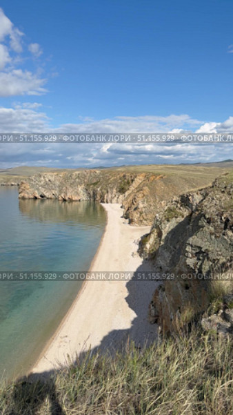 Baikal Lake on sunny August day. Vertical panoramic video of Small Sea and sandy beach of Olkhon Island. Picturesque landscape. Natural background. Summer travel and outdoor recreation. Стоковое видео, видеограф Виктория Катьянова / Фотобанк Лори