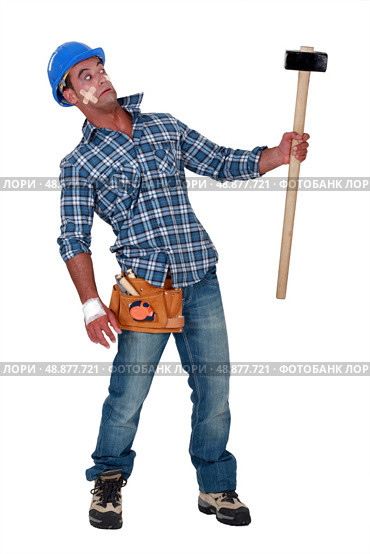 Bandaged construction worker wary of a sledgehammer. Стоковое фото, агентство Ingram Publishing / Фотобанк Лори