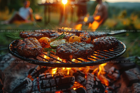 Barbecue moment in nature. Shown in the foreground is a grill cooking succulent cuts of meat and vegetables such as tomatoes and zucchini. The flames under the grill create a bright, warm glow that brings out the texture and deliciousness of your food. Стоковое AI-изображение, AI-художник Анна Кривицкая / Фотобанк Лори