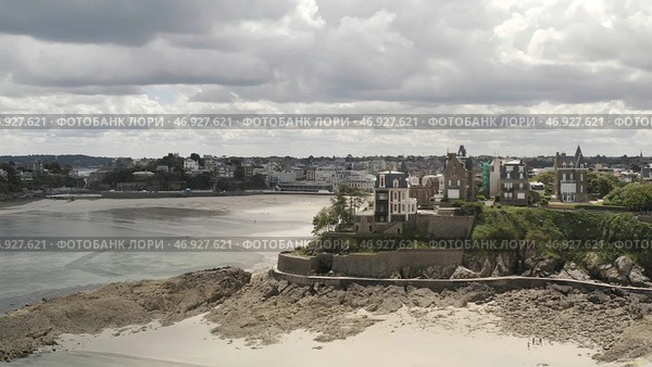 Beautiful aerial view of grey old European city near the sand riverside in summer against grey cloudy sky. Стоковое фото, фотограф David Kashakhi / Фотобанк Лори