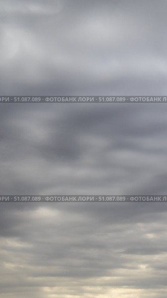 Beautiful dark dramatic sky with stormy clouds before rain or snow. Thunderstorm heaven landscape. Timelapse. Стоковое фото, фотограф Feruza Tashmetova / Фотобанк Лори