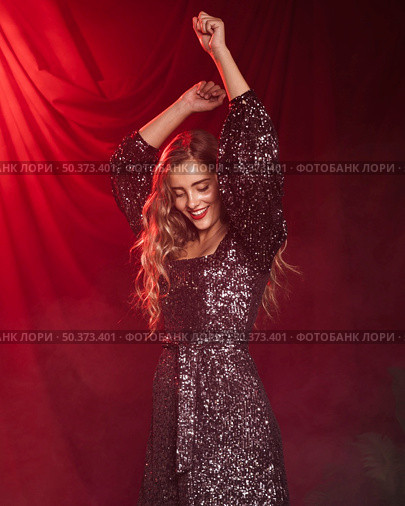 beautiful woman smiling dancing red curtain background. Стоковое фото, агентство Ingram Publishing / Фотобанк Лори
