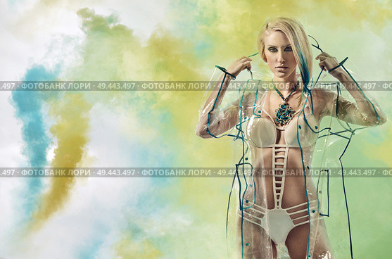 Beautiful young lady wearing a transparent raincoat. Стоковое фото, агентство Ingram Publishing / Фотобанк Лори