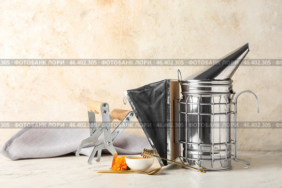 Beekeeping supplies and honey on table. Стоковое фото, фотограф Pixel_shot / Фотобанк Лори