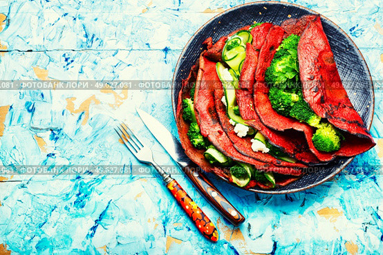 Beetroot pancakes with feta cheese, broccoli and cucumber. Copy space. Fresh pancakes from beetroot. Стоковое фото, агентство Ingram Publishing / Фотобанк Лори
