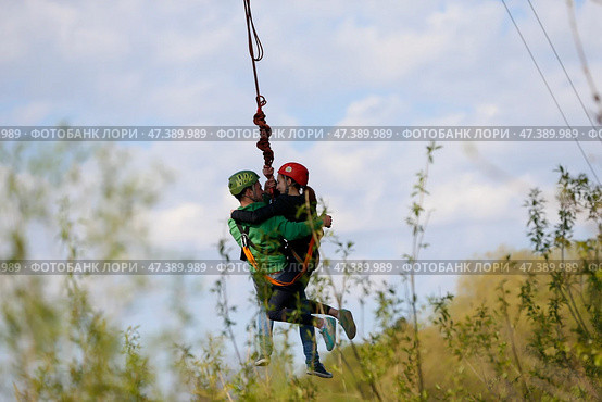 Belarus, Gomel, May 01, 2017.Jumping with a rope.Love couple jumping with rope.Engage in extreme sports. Risky love story. Редакционное фото, фотограф Лазаренко Светлана / Фотобанк Лори