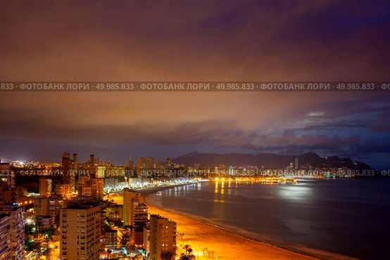 Benidorm beaches and skyscrapers at evening, known throughout Europe as Spanish major tourist destination with thousands of visitors a year.. View of Benidorm at night. Стоковое фото, агентство Ingram Publishing / Фотобанк Лори