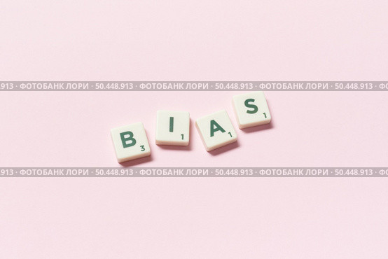 Bias word formed of scrabble tiles on pink background. Creative template with human rights concept.. Bias formed of scrabble tiles on pink background. Стоковое фото, агентство Ingram Publishing / Фотобанк Лори