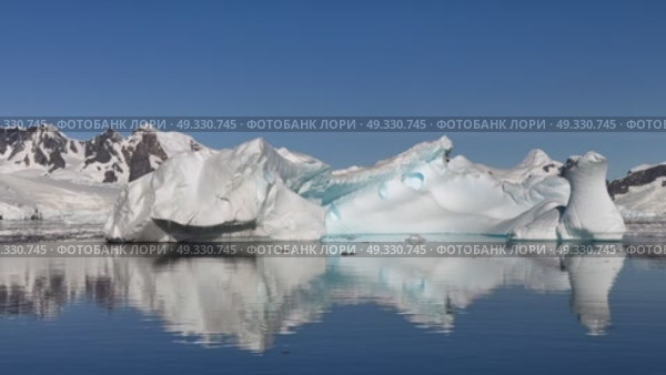 Big Iceberg in Antarctica Winter Scenery, Amazing Shape Ice Formation of Massive Large Enormous Blue Icebergs in Antarctic Peninsula Landscape Seascape with Ocean Sea Water. Стоковое видео, видеограф Vladimir / Фотобанк Лори