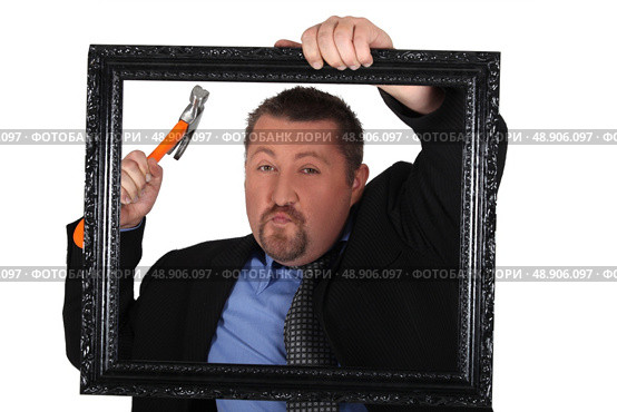 Black man hanging frame. Стоковое фото, агентство Ingram Publishing / Фотобанк Лори