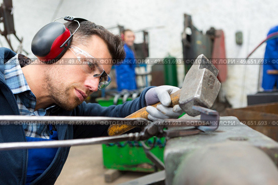 blacksmiths work as forging forging on metal. Стоковое фото, агентство Ingram Publishing / Фотобанк Лори