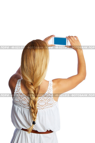 Blond tourist girl taking photos with smartphone on white background and braid. Стоковое фото, агентство Ingram Publishing / Фотобанк Лори