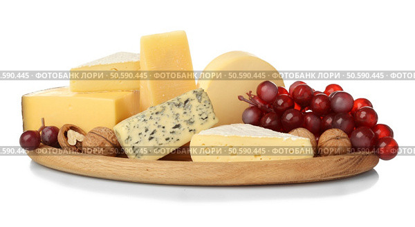 Board with assortment of delicious cheese, grape and nuts on white background. Стоковое фото, агентство Ingram Publishing / Фотобанк Лори