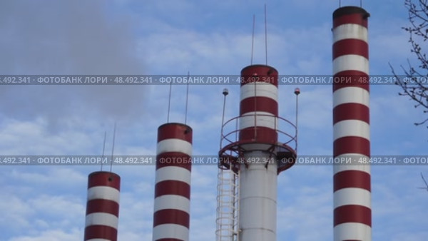 Boiler room chimneys against blue sky background. Стоковое видео, видеограф Igor Skripachev / Фотобанк Лори